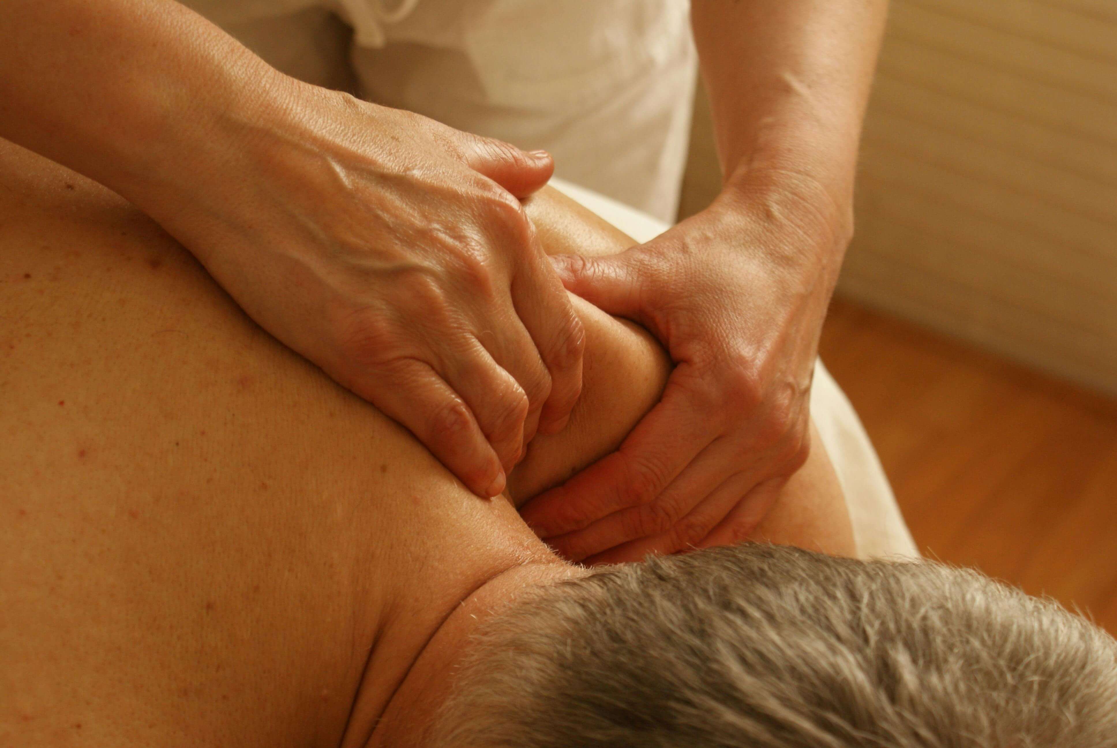 an elite massage escort massaging her client