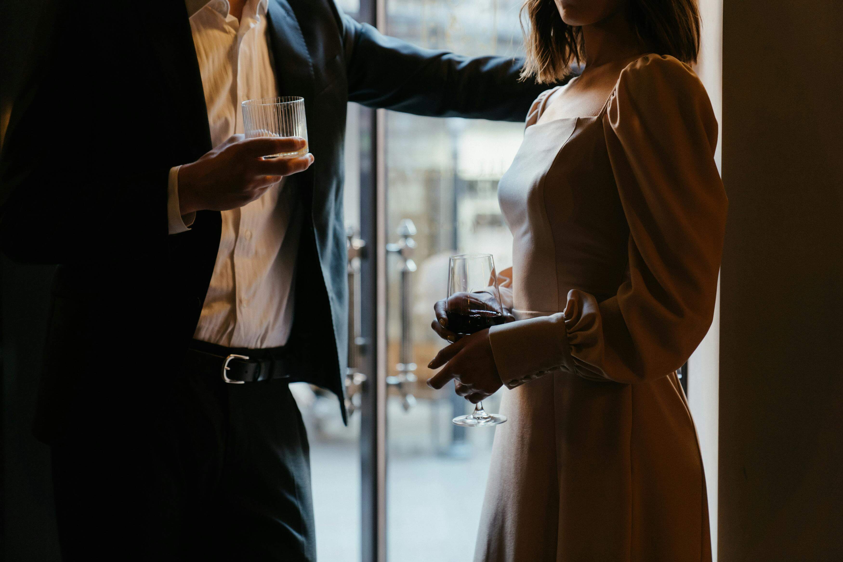 a high class escort having a drink with a client