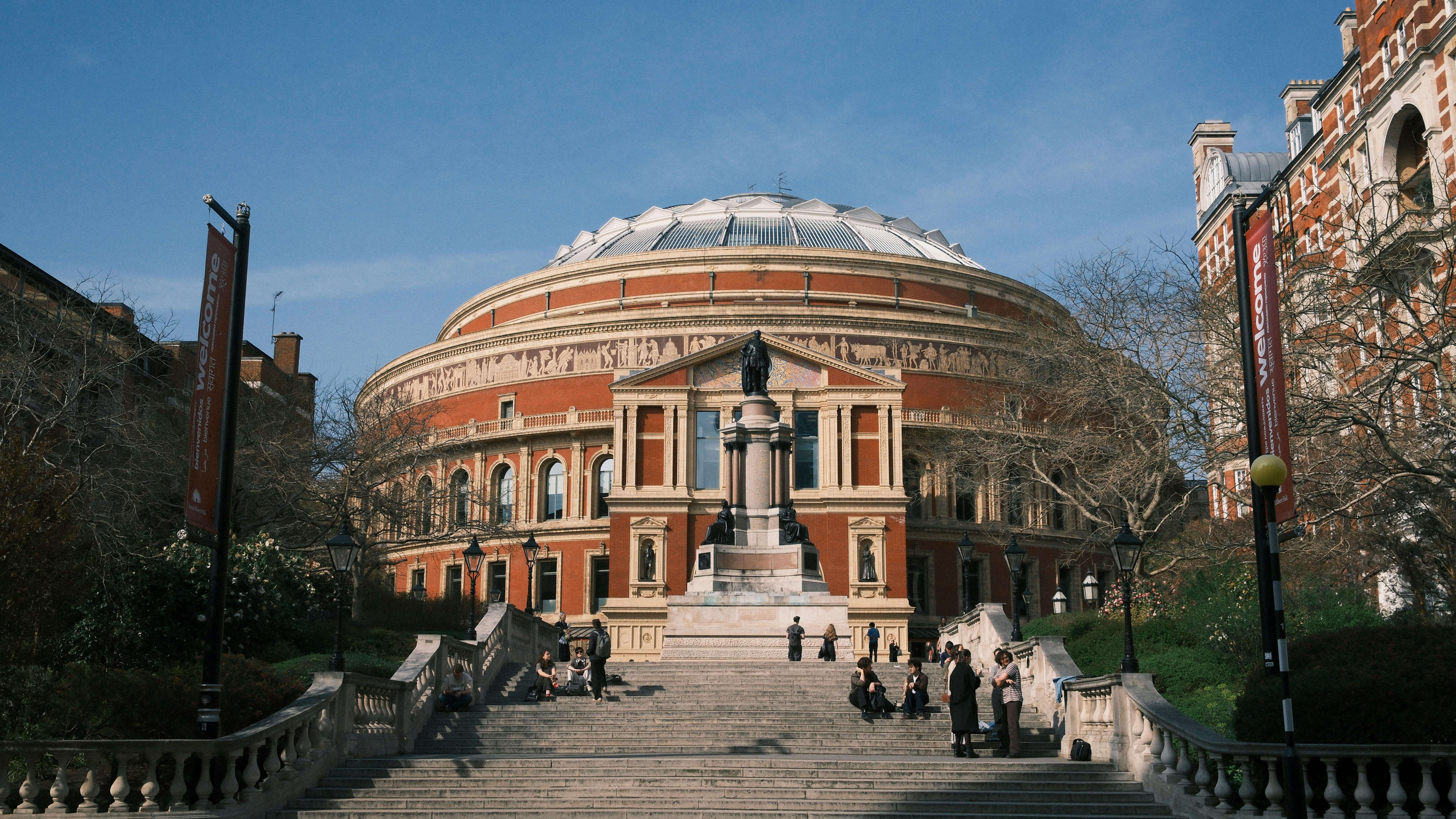 a view of the Royal Albert Hall with people on the steps