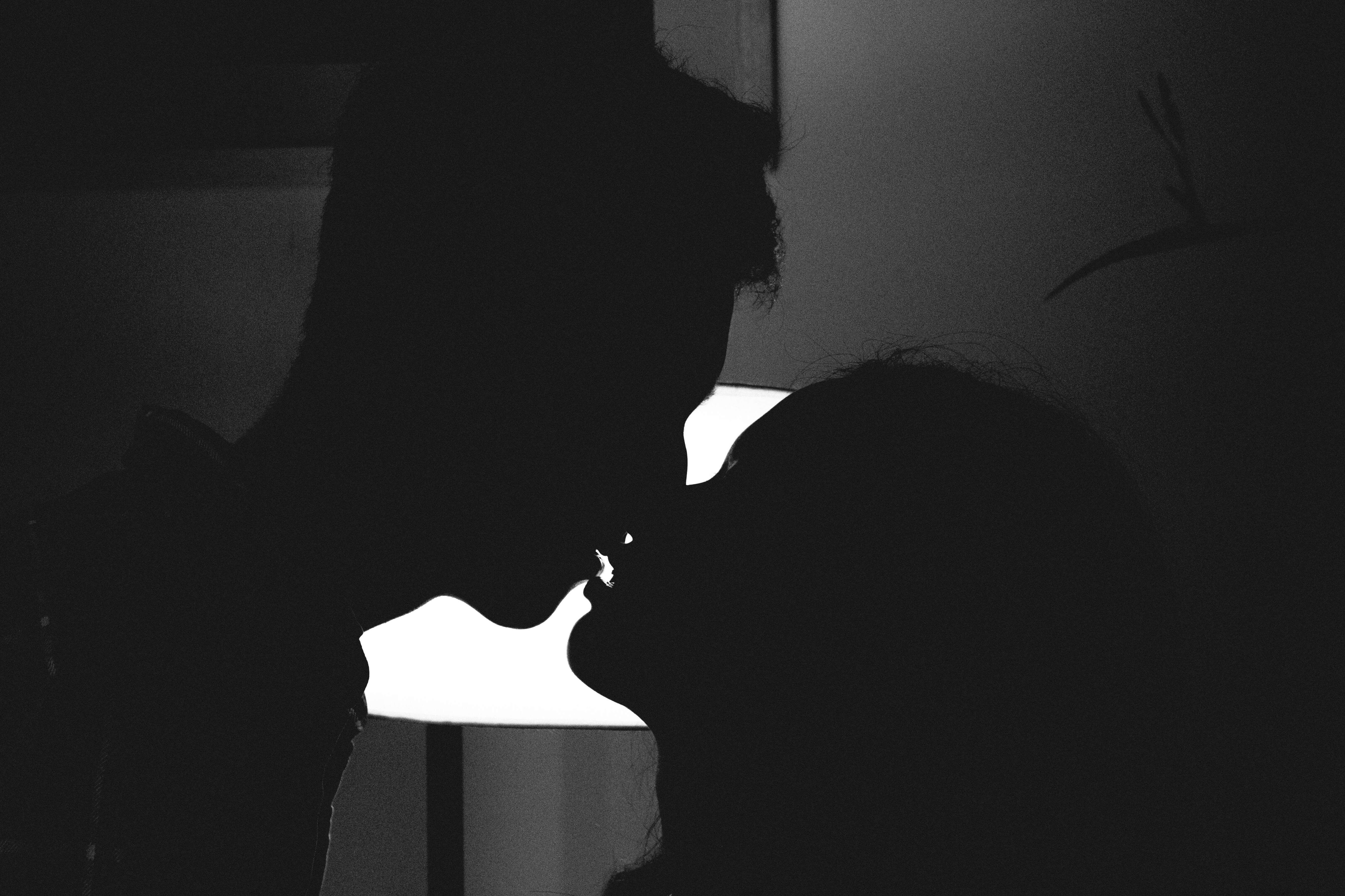 a client and escort about to kiss in black and white
