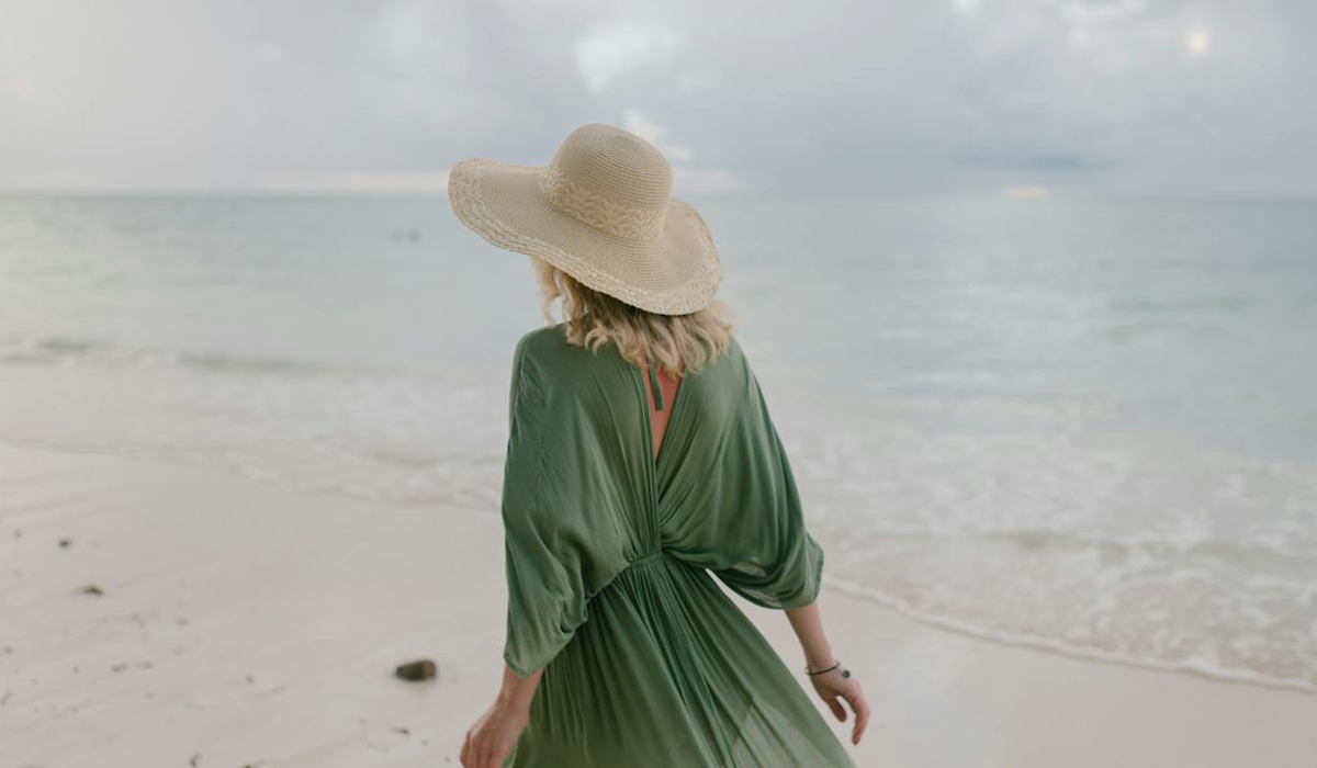 By the beach with a pretty companion in a green Summer dress.