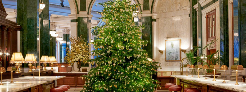 The Ned London Christmas tree lit up next to the bar