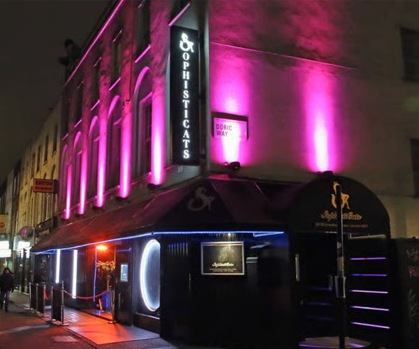 Outside the sophisticats club, lit up in purple at night