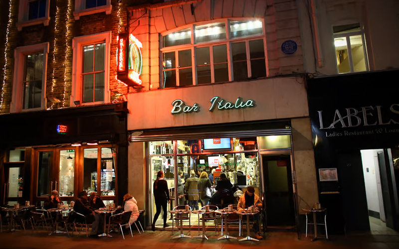 Outside Bar Italia lit up in the evening